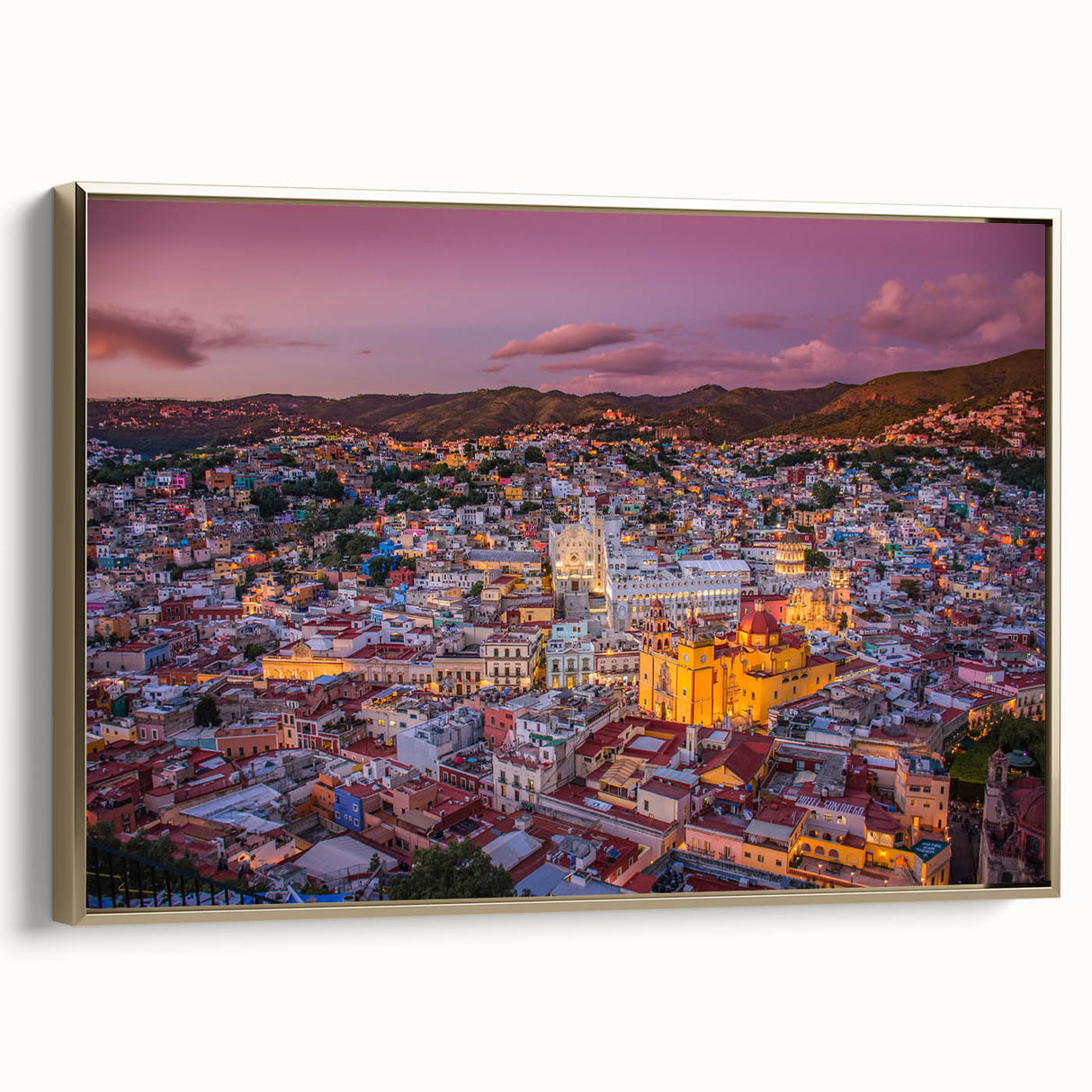 Framed canvas depicting a vintage landscape painting of Guanajuato, Mexico in muted gold and black tones.