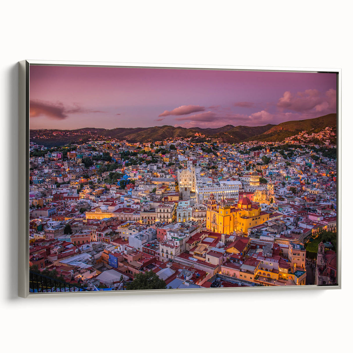 Framed canvas landscape art painting of Guanajuato, Mexico, featuring vibrant, colorful buildings and a black sky.