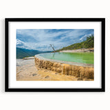 Abstract art print of a vibrant, colorful Oaxaca scenery on textured canvas, framed in black, ideal for living room decor.