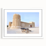 Abstract art print of a Middle Eastern scenery in muted earth tones on a framed white mat, ideal for dining room decor.