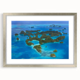 Textured abstract art print in muted blue and white tones, framed in silver, ideal for bedroom wall decor.