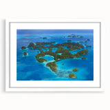 Abstract art print depicting an oceanic scene in cool blue tones, framed with a white mat, suitable for dining room decor.