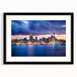 Extra large abstract art print depicting vibrant, colorful Auckland skyline on textured canvas, framed in black.