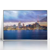 Framed acrylic print of Auckland skyline in art deco style, featuring pastel colors, ideal for modern nursery wall art.