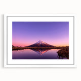 Abstract art print of New Zealand's Taranaki scenery in muted blue and green tones, framed in white.