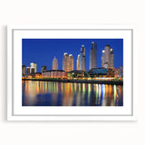 Abstract art print of Buenos Aires skyline in muted blue and gray tones on a framed white mat.