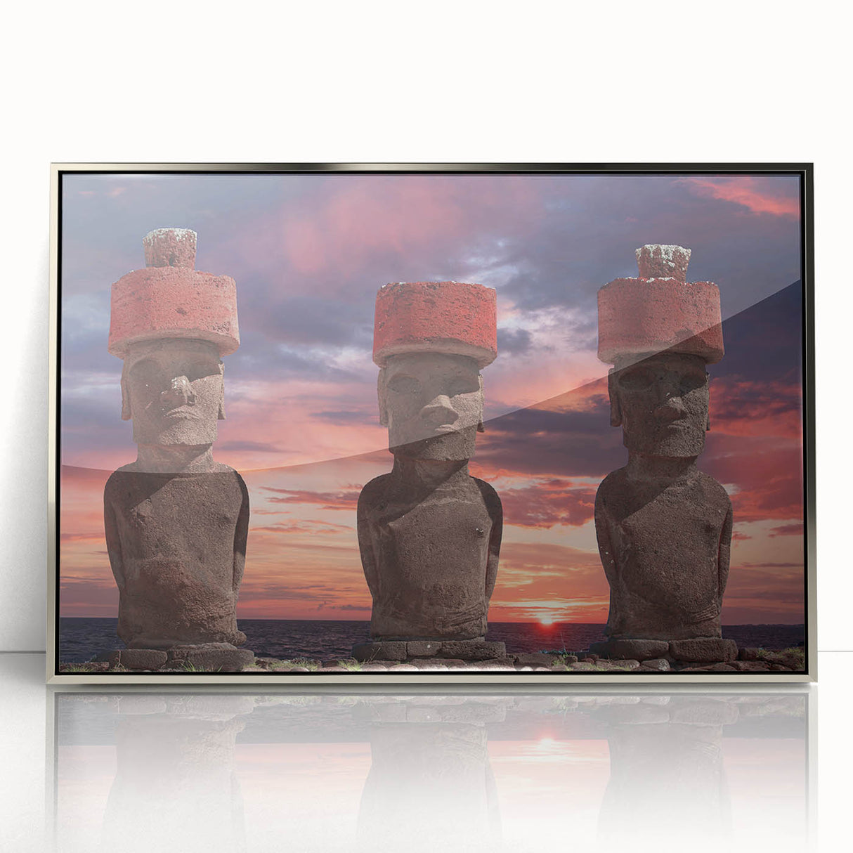 Mid-century modernist art featuring Easter Island statues in muted earth tones, displayed in a silver-framed acrylic print.
