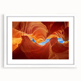 Abstract art print of Antelope Canyon in Arizona, featuring swirling orange and red rock formations, framed in white.