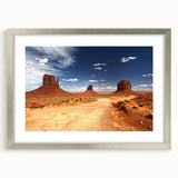 Textured art print of Monument Valley in muted earth tones on a framed canvas, suitable for bedroom decor.