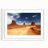 Abstract art print of Monument Valley in muted earth tones on a framed white mat, suitable for bedroom or dining room decor.
