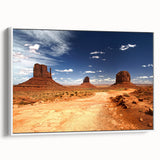 Vintage poster art of Monument Valley in vibrant red and orange tones on a large framed canvas, ideal for living room decor.