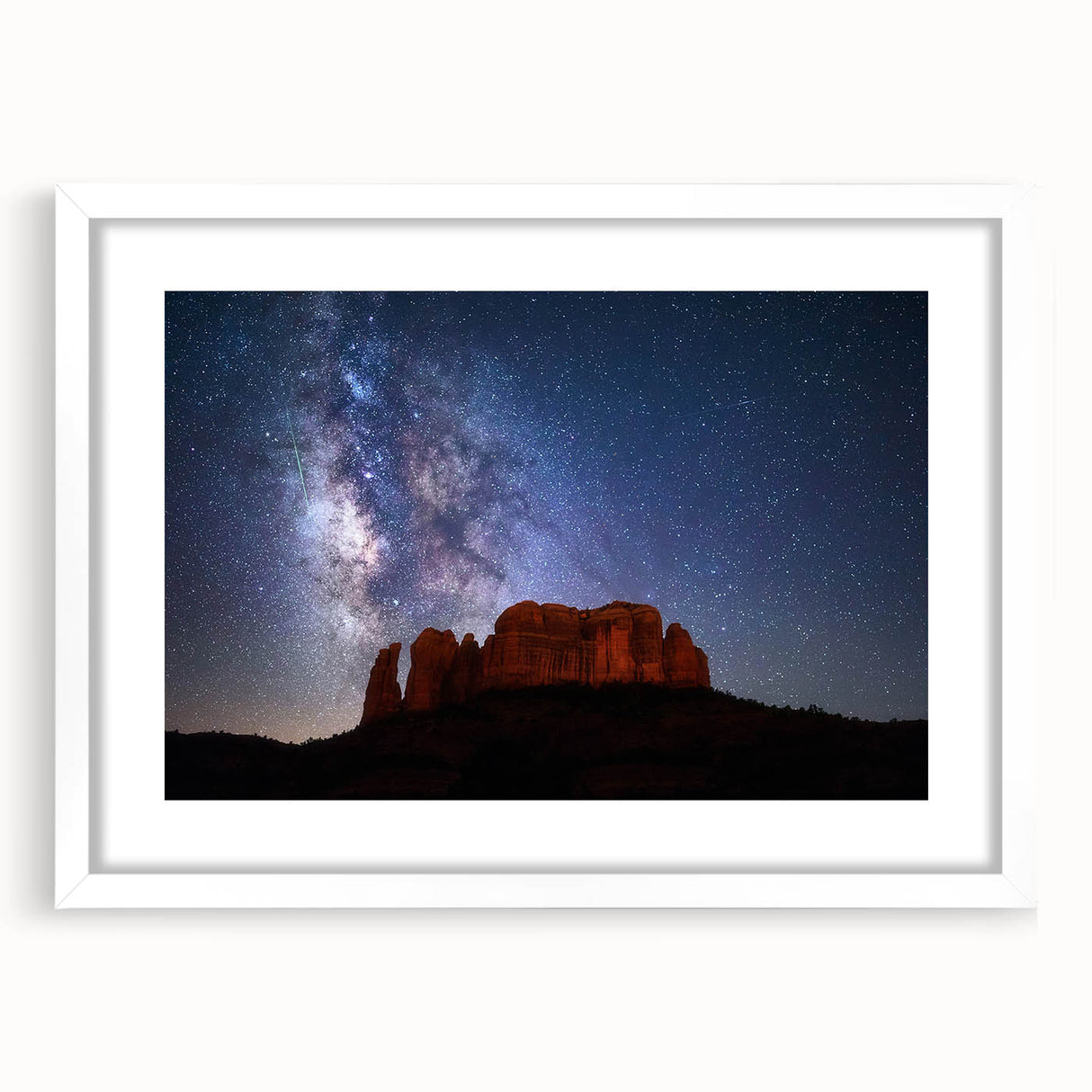Abstract art print of Sedona landscape in muted orange and red tones on a framed white mat, suitable for dining room decor.