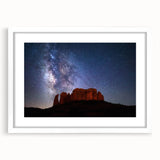 Abstract art print of Sedona landscape in muted orange and red tones on a framed white mat, suitable for dining room decor.