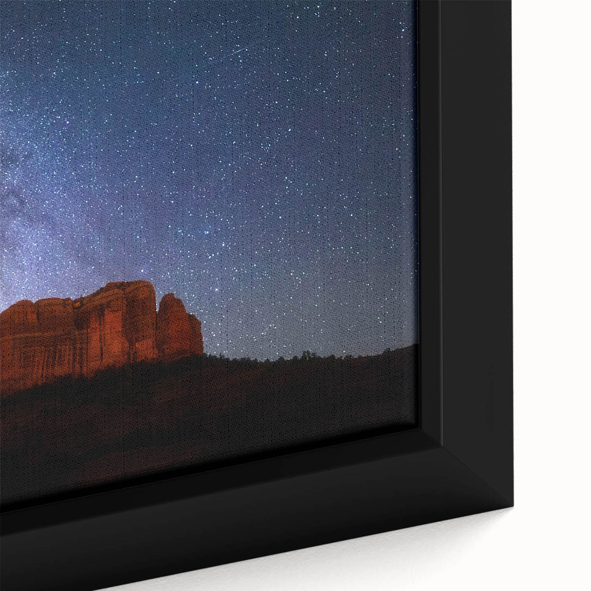 Close-up of textured black wall art depicting Sedona, Arizona, with colorful accents on a framed canvas.
