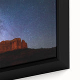 Close-up of textured black wall art depicting Sedona, Arizona, with colorful accents on a framed canvas.