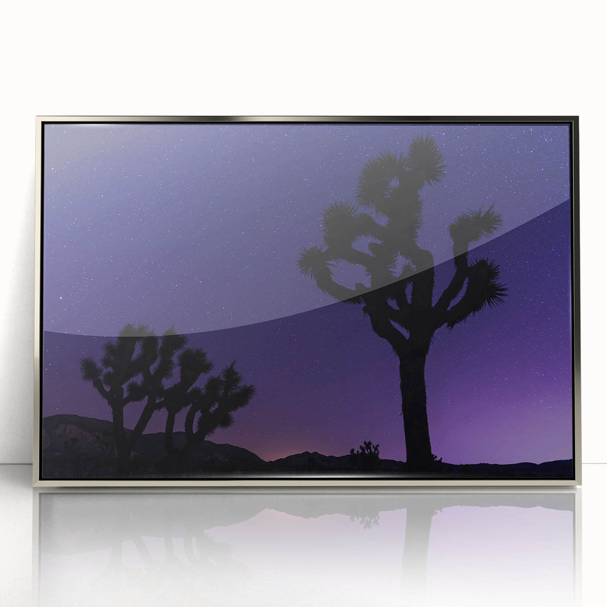 Mid-century modernist art depicting a Joshua Tree in muted earth tones on a silver-framed acrylic print.