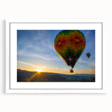 Abstract art print of Napa Valley with muted green and earth tones in a white frame, ideal for dining room decor.