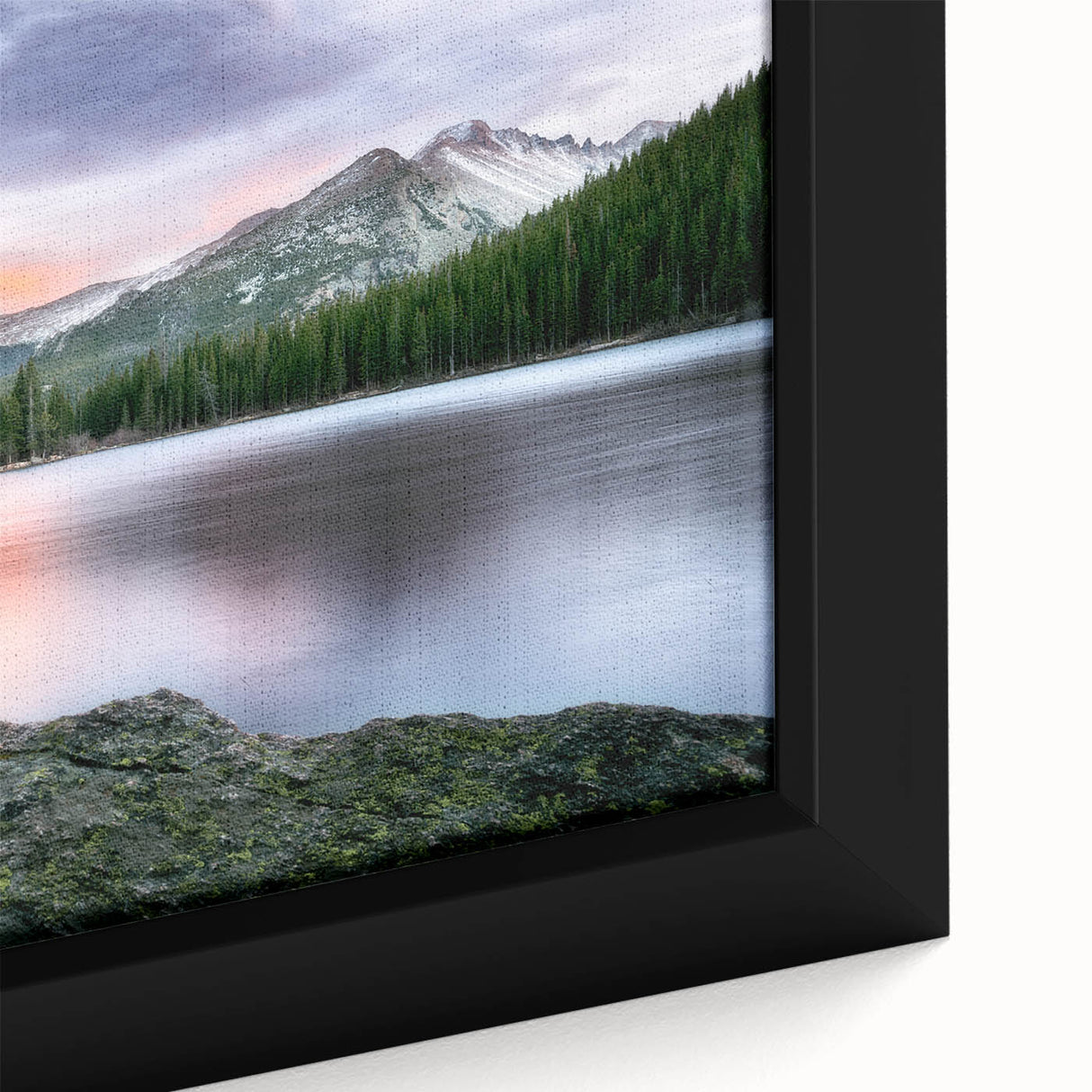 Close-up of a textured, colorful art piece depicting the Rocky Mountains on a black framed canvas.