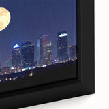 Close-up of a framed canvas featuring a textured depiction of Tampa's skyline in black with colorful accents.
