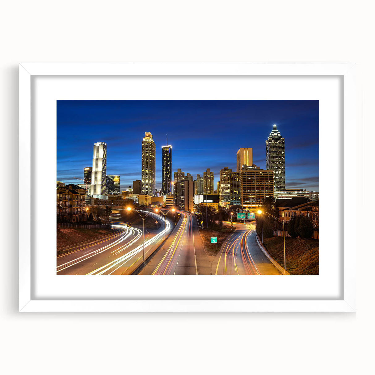 Abstract art print of Atlanta skyline in muted blue and gray tones on a framed white mat, ideal for dining room decor.