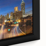 Close-up of a textured black wall art depicting the Atlanta skyline in vibrant colors on a framed canvas.