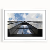 Abstract art print of Chicago skyline in muted gray and blue tones, framed in white.