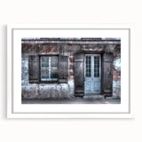 Abstract art print of New Orleans scenery in muted blue and green tones, displayed in a white frame with mat.