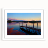 Abstract art print of Maine scenery in muted blue and green shades, framed with a white mat, suitable for dining room decor.