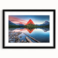 Colorful, abstract art print depicting Glacier National Park in vibrant hues, presented in a black frame with mat.