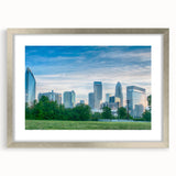 Abstract textured art print of Charlotte skyline in muted blue and gray, framed in silver, ideal for modern bedroom decor.