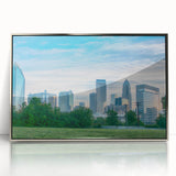 Mid-century modernist art depicting the Charlotte skyline in muted silver and blue tones on a framed acrylic print.