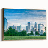 Framed canvas wall art featuring a black and white vintage poster of the Charlotte skyline, suitable for bedroom decor.