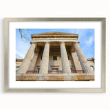 Textured art print of abstract Raleigh skyline in muted gray and blue tones on a framed silver canvas.