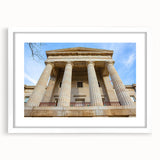 Abstract art print of Raleigh skyline in muted gray and blue tones on a framed white matte canvas.