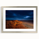 Textured art print of abstract North Dakota scenery in muted earth tones, framed in silver, ideal for bedroom decor.
