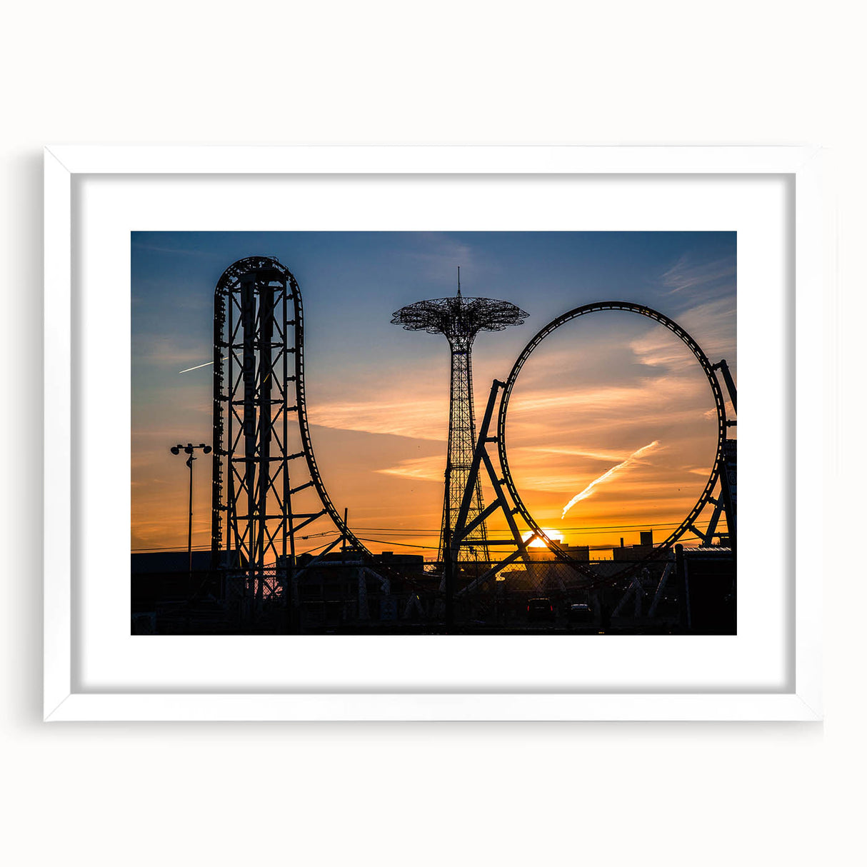 Abstract art print of Coney Island in muted blue and gray tones on a framed white canvas, suitable for dining room decor.