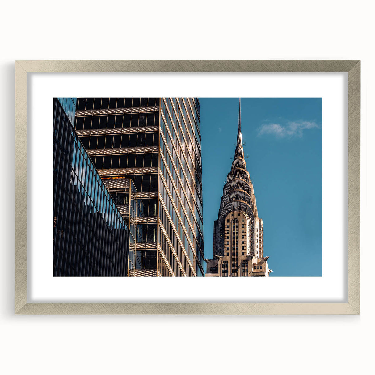 Textured art print of the Chrysler Building in muted gray tones, framed in silver, suitable for bedroom decor.