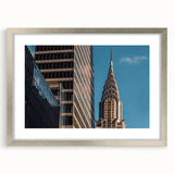 Textured art print of the Chrysler Building in muted gray tones, framed in silver, suitable for bedroom decor.