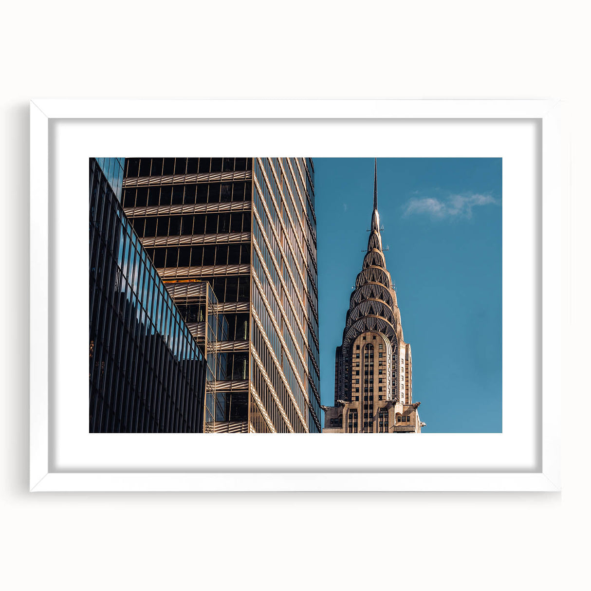 Abstract art print of the Chrysler Building in muted gray and blue tones, framed with a white mat.