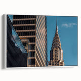 Vintage poster art of the Chrysler Building, featuring a monochrome palette with colorful accents on framed canvas.