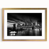 Extra large abstract art print of the Manhattan skyline in textured gold frame, suited for living room decor.
