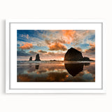 Abstract art print of Cannon Beach with soft blue and gray tones on a framed white mat, suitable for dining room decor.
