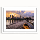 Abstract art print of Portland scenery in muted green and blue tones on a framed white matte canvas.