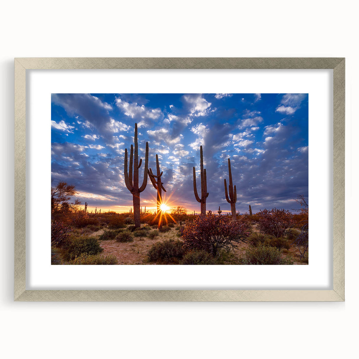 Textured art print of abstract Phoenix valley in muted earth tones, framed in silver, ideal for bedroom ambiance.