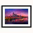 Colorful abstract art print of Nashville skyline in vibrant hues on a framed canvas, suitable for living room decor.