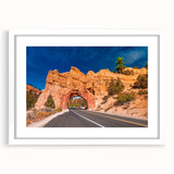 Abstract art print of Bryce Canyon in muted orange and red tones, framed with a white mat, suitable for dining room decor.