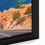 Close-up of a textured black wall art depicting Bryce Canyon, with vibrant red and orange hues, on a framed canvas.
