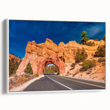 Framed canvas depicting a vintage poster art of Bryce Canyon, featuring vibrant red and orange tones.