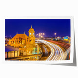 Floral art featuring soft pink blossoms over a muted green background on a large rolled canvas.