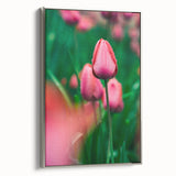 Framed canvas depicting a spring landscape with vibrant green and pink tones, ideal for brightening a living room wall.